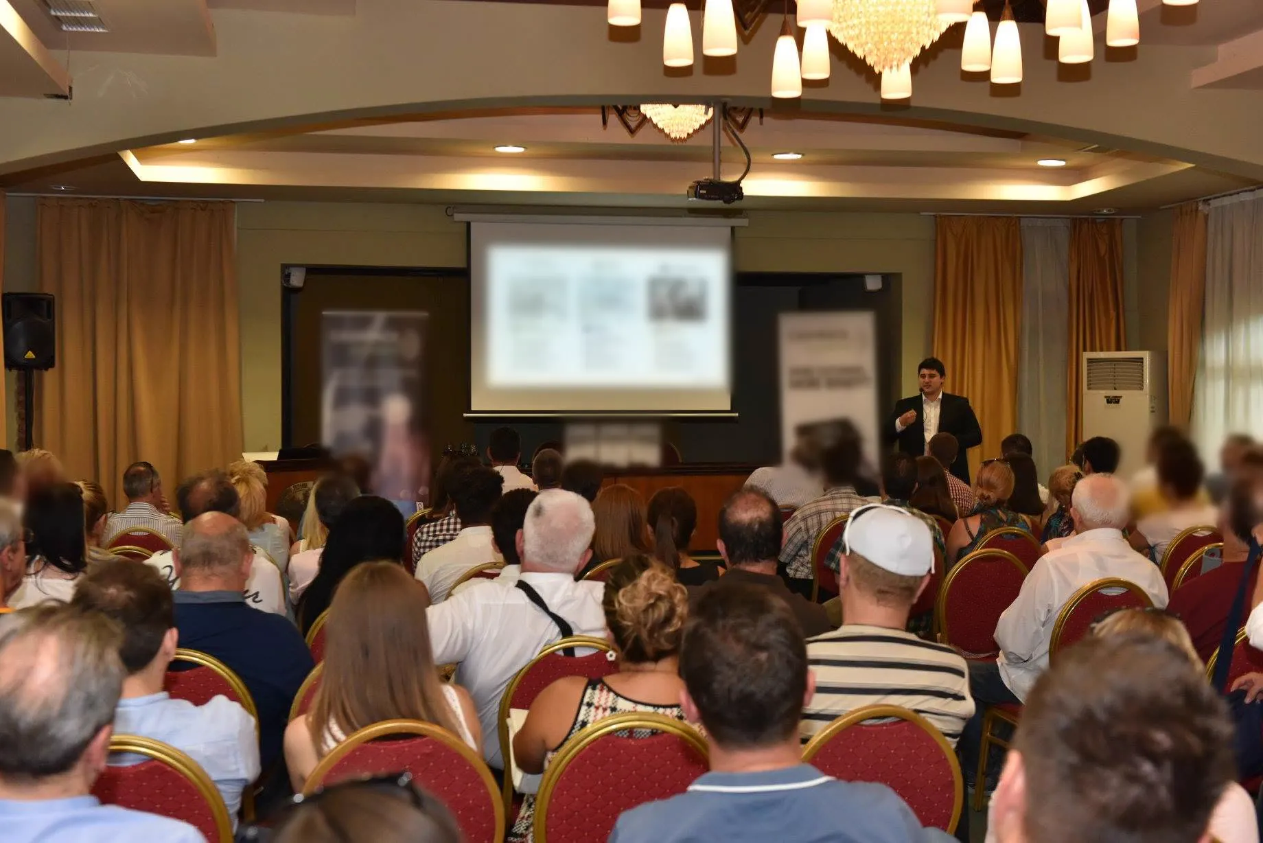 Dr. Radovan Vitosevic leading a seminar in front of a full room of participants